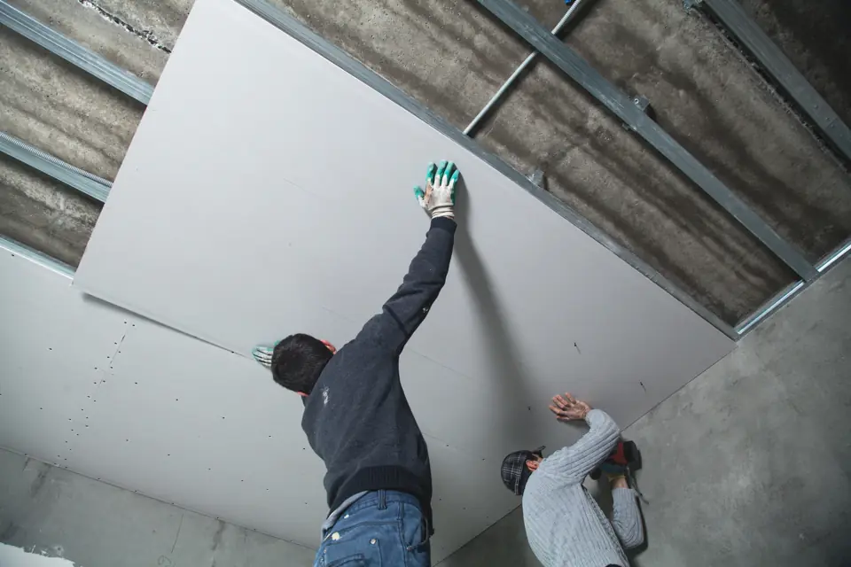 Crew installing new drywall during reconstruction