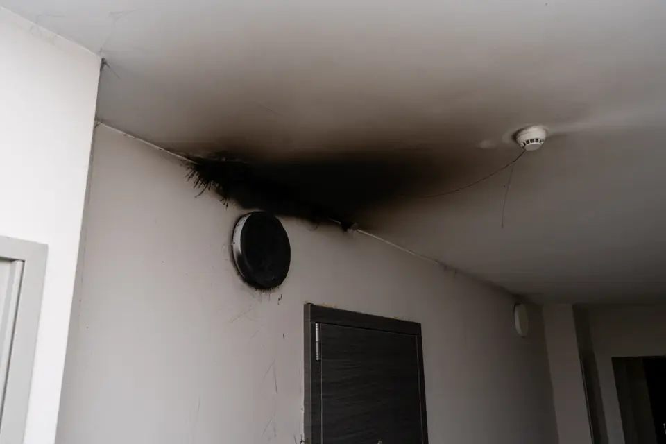 Smoke and soot damage on an interior wall and ceiling